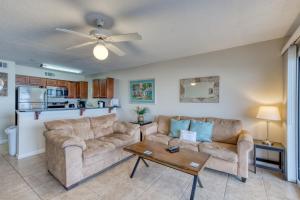 a living room with a couch and a table at Crystal Sands Condominiums in Destin