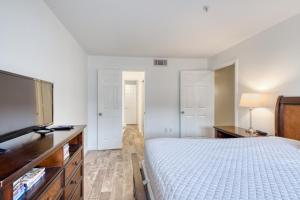 a bedroom with a bed and a flat screen tv at Crystal Sands Condominiums in Destin