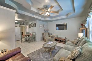 a living room with a couch and a ceiling fan at Long Island Village Escape with Deck and Pool Access! in Port Isabel