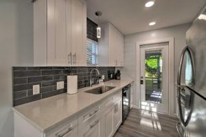 a kitchen with white cabinets and a sink at Charming Vacation Rental Close to Downtown! in Sarasota