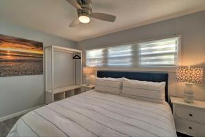 a bedroom with a large white bed with a window at Charming Vacation Rental Close to Downtown! in Sarasota