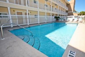 a swimming pool in front of a building at Crystal Sands III in Destin
