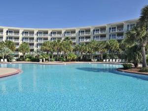 a large swimming pool in front of a large apartment building at Crescent IV in Destin