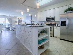 a kitchen with white cabinets and a large island at Crescent III in Destin