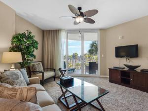 a living room with a couch and a tv at The Palms of Destin in Destin