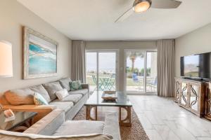 a living room with a couch and a tv at Windancer Condominiums in Destin