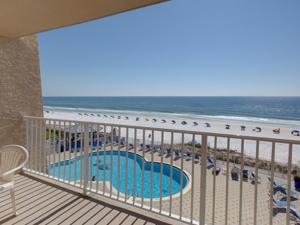 a balcony with a view of a pool and the beach at Beach House IV in Destin