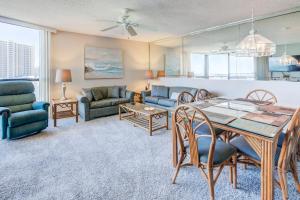 a dining room and living room with a table and chairs at Mainsail III in Destin