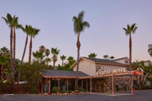 a hotel with palm trees in front of it at The Capri Hotel in Ojai