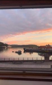 a view of a body of water with boats in it at Panoramic Harbour View Apartment in Oban