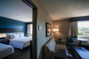 a hotel room with two beds and a television at Best Western Plus Chocolate Lake Hotel - Halifax in Halifax
