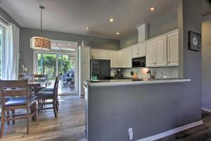 a kitchen and dining room with a table and chairs at Pet-Friendly Home with Grill, 2 Mi to Autzen Stadium! in Springfield