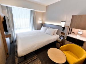Postel nebo postele na pokoji v ubytování Asakusa Tobu Hotel