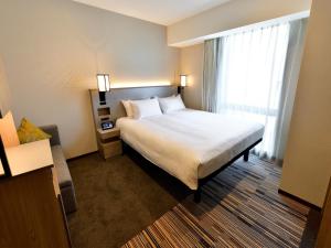 Postel nebo postele na pokoji v ubytování Asakusa Tobu Hotel
