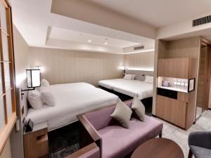 
a hotel room with a bed and a tv at Asakusa Tobu Hotel in Tokyo
