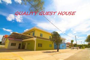 a yellow house with the words quality guest house at Quality Guest House in Kuantan