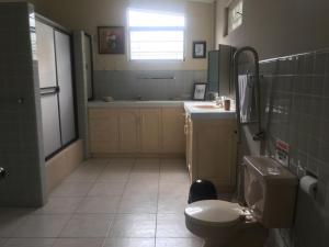 a bathroom with a toilet and a sink at Ilioni Boutique Hotel in Guayaquil