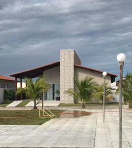 a building with palm trees in front of it at Casa de praia Luís Correia in Luis Correia