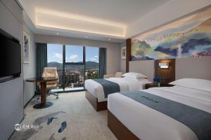 Postel nebo postele na pokoji v ubytování Ramada Encore by Wyndham Chenzhou North + 34 fotografií