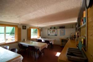 a dining room with two tables and chairs at Yellow Dog Lodge, Inc. in Yellowknife