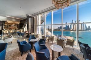 a restaurant with a view of the city at Luxury Apartment in Dubai's hottest Palm hotel in Dubai