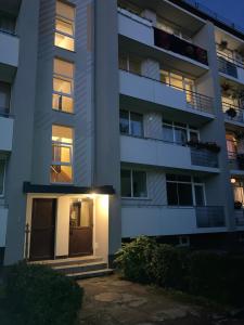 an apartment building with a door at night at apartamenti Zirnis in Cēsis