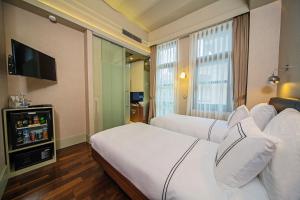 a hotel room with two beds and a flat screen tv at The Haze Karaköy in Istanbul