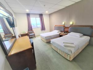 Кровать или кровати в номере Anika Inn - Kluang