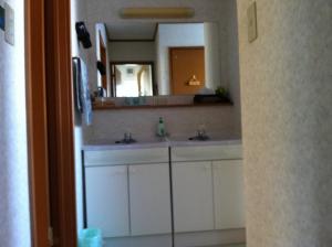 a bathroom with two sinks and a large mirror at 星空自慢の宿帯広八千代Starry Sky Inn in Obihiro +96 photos