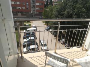 a balcony with two chairs and a parking lot at King apartment in Novi Sad