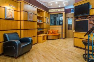 a waiting room with a chair and a tv at Hotel Avion - Self check in in Plovdiv