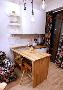 a kitchen with a wooden table in a room at Apartman Andric 2 in Valjevo