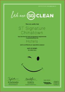 a green poster with a smiley face at ST Signature Chinatown in Singapore