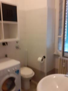 a bathroom with a toilet and a washing machine at CASA GIOVANNI in Milan