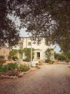a large white building with trees in front of it at B&B Giovannarolla Green House in Ostuni