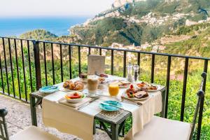 a table topped with plates of food and drinks at Hotel Villa Maria in Ravello