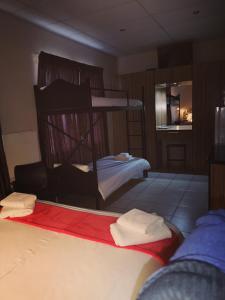 een slaapkamer met 2 stapelbedden en handdoeken bij AAA Rose Garden Guesthouse in Mookgophong
