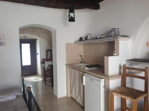 a kitchen with a sink and a counter top at Giardino Dei Trulli in Alberobello