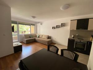 a living room with a table and a couch at Apartments Dione in Pomorie