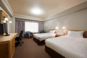Rúm í herbergi á Hotel Agora Regency Osaka Sakai