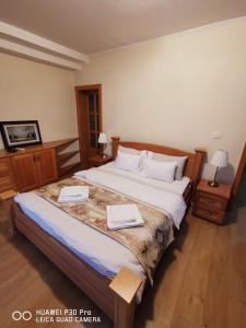 a bedroom with a large bed with two books on it at Vila Orešac in Smederevo +62 photos
