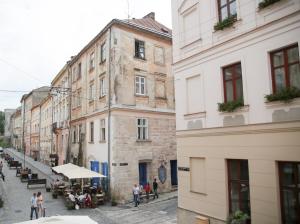 a street in an old town with people walking around at Lviv4U in Lviv