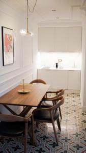 a dining room with a wooden table and chairs at Casa Timoteo Apartamentos Boutique Adults Only in Alcoy