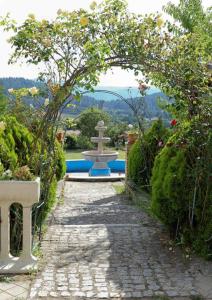 a stone path leading to a fountain in a garden at Villa Concetta in San Giovanni in Fiore