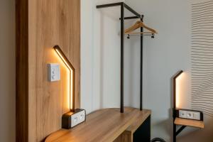 a room with a desk with two lights on it at B&B HOTEL Ouistreham in Ouistreham