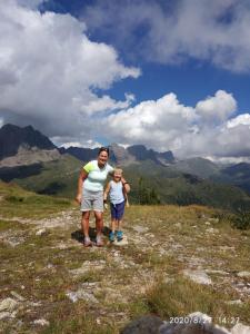 a man and a child standing on top of a mountain at Hotel Serenella in Canale San Bovo
