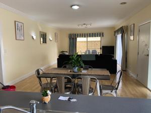 a living room with a table and chairs and a couch at Apartment 244 on Bertha, Mount Gambier in Mount Gambier