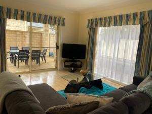 a living room with a couch and a television at Apartment 244 on Bertha, Mount Gambier in Mount Gambier