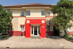 a house with red paint on the front of it at RedDoorz @ Pavilion Residence Cikarang in Jakarta