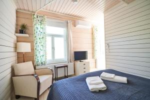 ナウヴォにあるKöpmansのベッドルーム(ベッド1台、椅子、テレビ付)